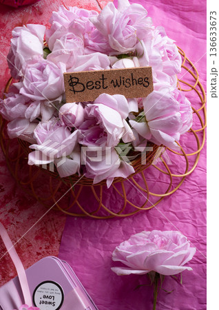 roses bouquet against double pink color background with "best wishes". romantic concept roses bouquet against double pink color background with "best wishes". romantic concept 136633673