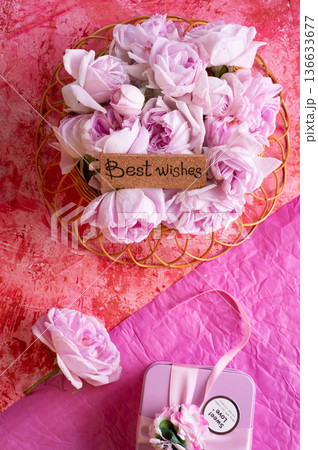 roses bouquet against double  pink color  background with "best wishes" words. romantic and beauty concept 136633677
