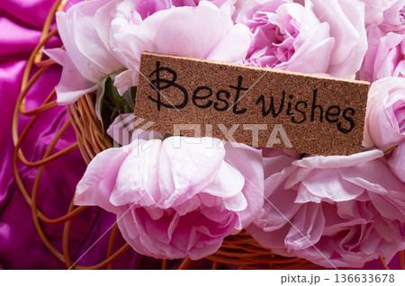 roses bouquet against  pink color  background with "best wishes" words. romantic and beauty concept 136633678