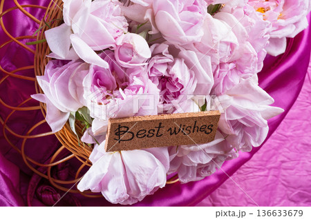 roses bouquet against  pink color  background with "best wishes" words. romantic and beauty concept 136633679