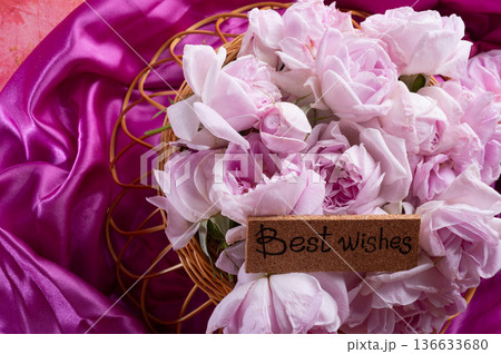 roses bouquet against pink color background with "best wishes" words. romantic and beauty concept roses bouquet against pink color background with "best wishes" words. romantic and beauty concept 136633680
