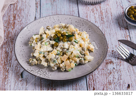 Savory salad with eggs, cheese, peas and chives on a plate on the table Savory salad with eggs, cheese, peas and chives on a plate on the table 136633817