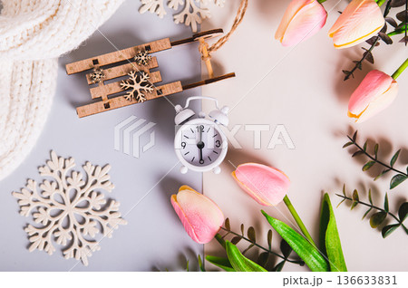 Close up of the concept of the spring equinox, the time between snow and flowers top view Close up of the concept of the spring equinox, the time between snow and flowers top view 136633831