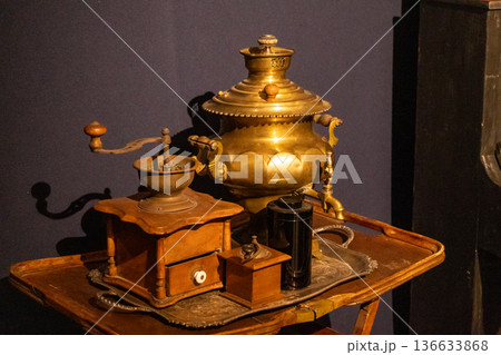 Old coffee grinder and copper samovar. Metal utensils Old coffee grinder and copper samovar. Metal utensils 136633868