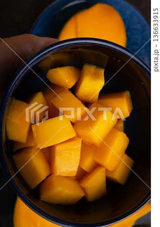 Ripe and tasty vibrant orange egyption Mango cubes. close up Ripe and tasty vibrant orange egyption Mango cubes. close up 136633915
