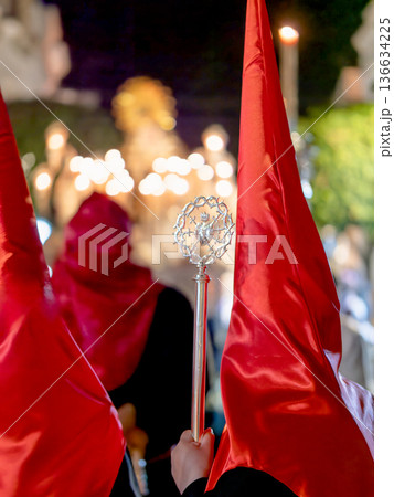 Back view of a nazareno in red hoods with silver scepter. Back view of a nazareno in red hoods with silver scepter. 136634225