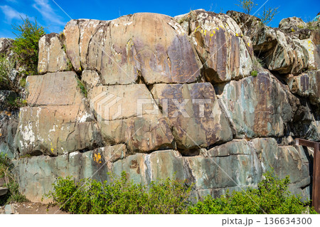 Petroglyphs at Kalbak-Tash rock art complex Altai Russia. Ancient carvings showcasing prehistoric cultural heritage. Petroglyphs at Kalbak-Tash rock art complex Altai Russia. Ancient carvings showcasing prehistoric cultural heritage. 136634300
