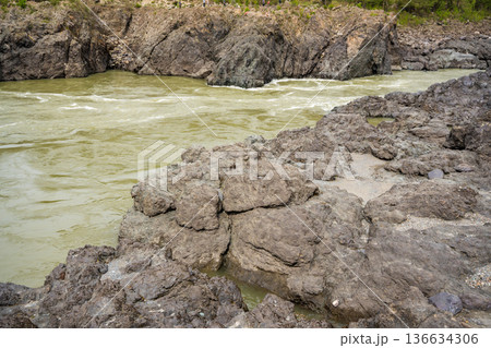 Narrowest and deepest section of Katun river with lava banks in Altai Russia. View from rocky gorge. Narrowest and deepest section of Katun river with lava banks in Altai Russia. View from rocky gorge. 136634306
