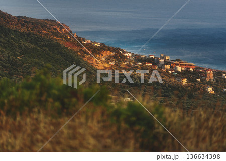 Scenic Golden Hour Landscape of Coastal Village 136634398