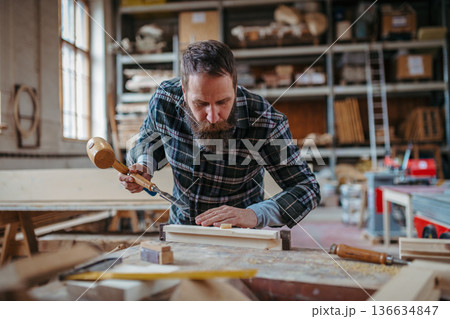 Male carpenter working on his product in workshop. Small business concept. 136634847