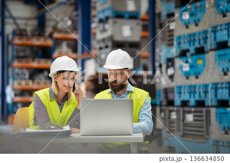 Industrial team analyzing data in high tech manufacturing plant. 136634850