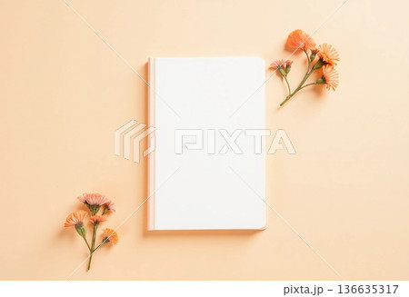 In a serene setting, a blank notepad lies open with delicate flowers surrounding it, creating a peaceful atmosphere perfect for writing or sketching thoughts and ideas Generative AI 136635317