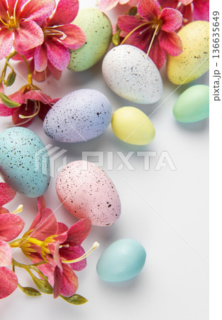 Pastel easter eggs with speckles and spring flowers 136635649