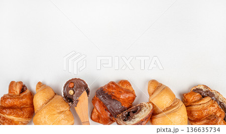 Fresh croissants with chocolate filling on white background with copy space 136635734