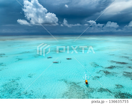 Aerial view of tourist boats in crystal clear turquoise sea Aerial view of tourist boats in crystal clear turquoise sea 136635755