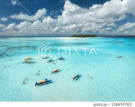 Aerial view of boats in turquoise sea, blue sky with clouds 136635765