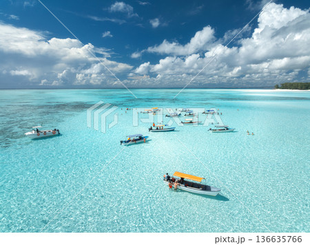 Aerial view of boats in turquoise sea, blue sky with clouds Aerial view of boats in turquoise sea, blue sky with clouds 136635766