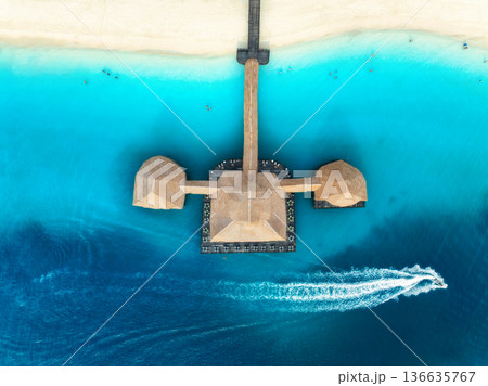 Aerial top view of luxury wooden pier and thatched roof bungalow Aerial top view of luxury wooden pier and thatched roof bungalow 136635767