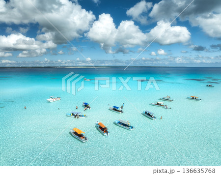 Aerial view of boats in turquoise sea under blue sky with clouds Aerial view of boats in turquoise sea under blue sky with clouds 136635768