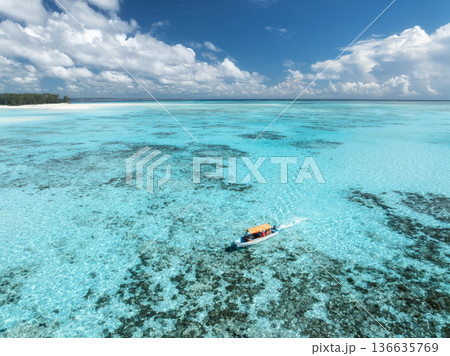 Aerial view of a boat in turquoise sea with transparent water 136635769