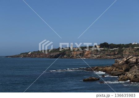 Guia Lighthouse on the rocky coastline of Cascais, Portugal 136635983