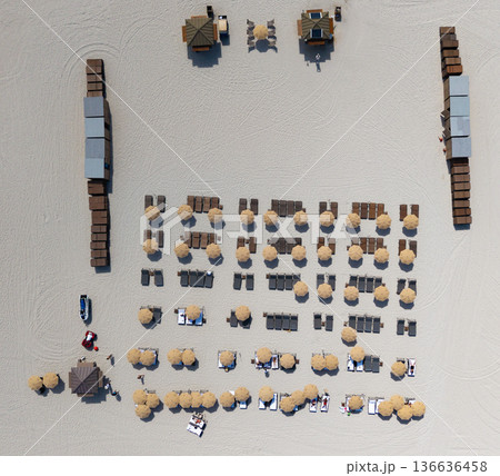 Travel to sea. Luxury resort. Aerial top view of sand beach with sunbed and umbrella. Summer vacation. Beach vacation at sea in summer. Sea relax under beach umbrella. Coastal retreat Travel to sea. Luxury resort. Aerial top view of sand beach with sunbed and umbrella. Summer vacation. Beach vacation at sea in summer. Sea relax under beach umbrella. Coastal retreat 136636458