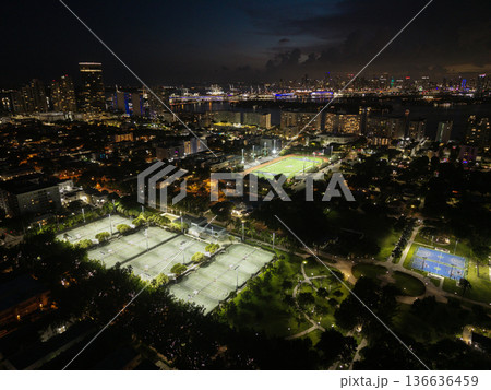 Miami, Florida, USA - June 10, 2025: Night Miami beach cityscape. Tennis field top aerial view at night. Sport activity in Flamingo park. Sport activity. Aerial basketball and football field in park Miami, Florida, USA - June 10, 2025: Night Miami beach cityscape. Tennis field top aerial view at night. Sport activity in Flamingo park. Sport activity. Aerial basketball and football field in park 136636459