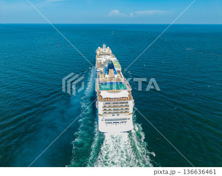 Cruise ship vacation. Aerial view of cruise ship in vacation summer. Cruise ship vacation and travel at sea. Aerial drone view of luxury liner. Ship heading to seascape horizon 136636461