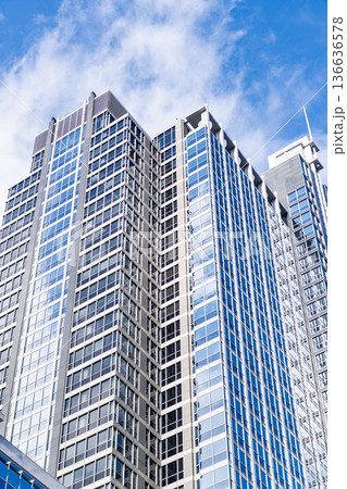 Business city. City architecture. Modern glass building. Reflective glass architecture. Architecture business district. Building architecture. Business building. Glass building. Urban business core Business city. City architecture. Modern glass building. Reflective glass architecture. Architecture business district. Building architecture. Business building. Glass building. Urban business core 136636578
