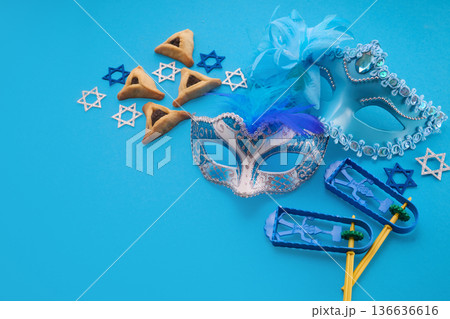 Purim holiday attributes on blue background arranging for celebration Purim holiday attributes on blue background arranging for celebration 136636616