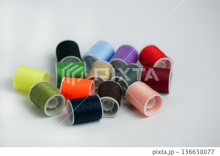 Bright multicolor thread spools on white background. Sewing, tailoring and DIY craft concept with copy space. High resolution image Bright multicolor thread spools on white background. Sewing, tailoring and DIY craft concept with copy space. High resolution image 136638077