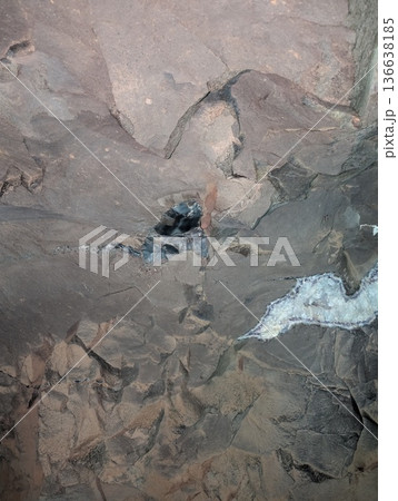 An undeveloped Amethyst geode in basalt rock in a tunnel at the Wanda mines in Misiones Province, Argentina An undeveloped Amethyst geode in basalt rock in a tunnel at the Wanda mines in Misiones Province, Argentina 136638185