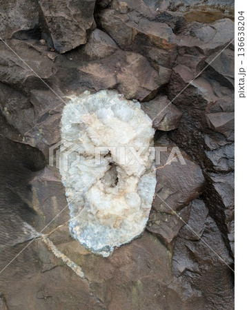 An amethyst geode in a wall at the Vanda mines in Misiones Province, Argentina. The quartz formation is white in color An amethyst geode in a wall at the Vanda mines in Misiones Province, Argentina. The quartz formation is white in color 136638204