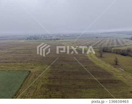 Vast Empty Farmland, Expansive Fallow Terrain Showing Stubble And Distant Settlement Scene Vast Empty Farmland, Expansive Fallow Terrain Showing Stubble And Distant Settlement Scene 136638463