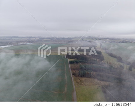 Misty High Altitude View Across Farmland, Ethereal Aerial Perspective Over Fragmented Farming Areas Misty High Altitude View Across Farmland, Ethereal Aerial Perspective Over Fragmented Farming Areas 136638544