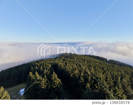 Sunrise Over Majestic Forested Ridge, Sunlit Mountain Ridge Emerges Above Floating Sea Of Clouds At Dawn Sunrise Over Majestic Forested Ridge, Sunlit Mountain Ridge Emerges Above Floating Sea Of Clouds At Dawn 136638578