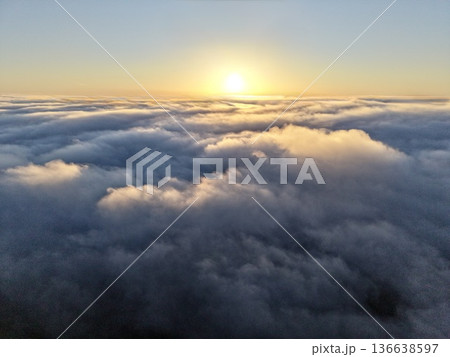 Calm Sunrise Scene, Serene Morning Illumination Highlighting Textured Summits Beneath Peaceful Sky 136638597