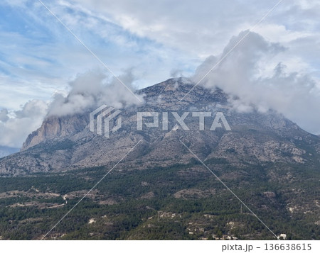 Misty Mountain Top Overlooking Village And Woods, Summit Shrouded In Mist With Scenic Hamlet Nearby 136638615