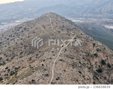 Trail Rugged Adventure, Unpaved Rocky Pathway Stretching Toward Distant High Point In Wilderness 136638639