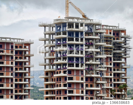 Tall Building Clusters And Cloud Cover, Skyscrapers With Repetitive Floors And Open Columns 136638683