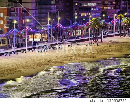 Serene Shore Illuminated By Colorful Lights, Calm Waterfront With Glowing String Lights And Silhouettes 136638722