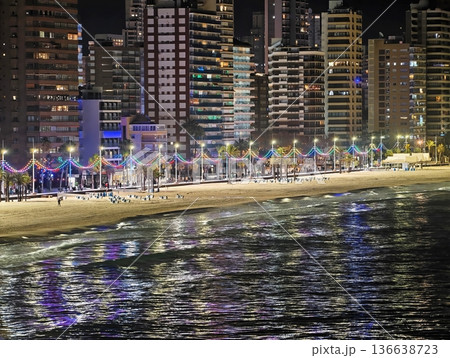 Nighttime Beach Walk With Lively Crowd, Celebratory Coastal Walk Among Palm Trees And Vibrant Lights Nighttime Beach Walk With Lively Crowd, Celebratory Coastal Walk Among Palm Trees And Vibrant Lights 136638723