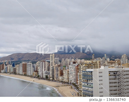 Serene Coastal Landscape, Peaceful Shoreline Under Cloudy Sky With Empty Promenade And Distant Hills Serene Coastal Landscape, Peaceful Shoreline Under Cloudy Sky With Empty Promenade And Distant Hills 136638740