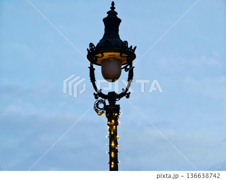 Elegant Night Illumination, Intricate Lamppost Illuminated With Gentle Amber Glow And Artistic Design Elegant Night Illumination, Intricate Lamppost Illuminated With Gentle Amber Glow And Artistic Design 136638742