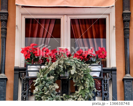 Holiday Decorations On Balcony, Urban Holiday Ambiance With Colorful Plants And Decorative Wreaths 136638748