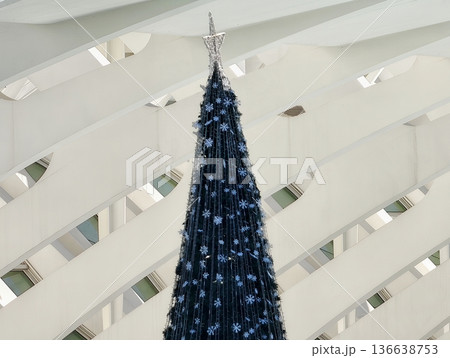 Decorative Christmas Tree Adorned With Navy Blue Ornaments Amidst Luminous Lighting And Architectural Details 136638753