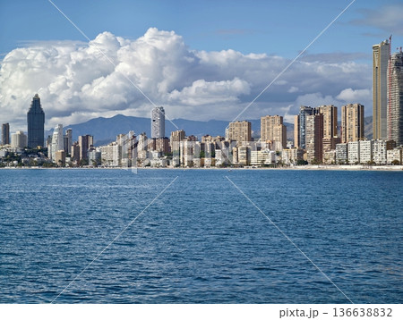 Serene Coastal Scene, Calm Waters Meet City Skyline, Peaceful Seaside With Urban Landscape View Serene Coastal Scene, Calm Waters Meet City Skyline, Peaceful Seaside With Urban Landscape View 136638832