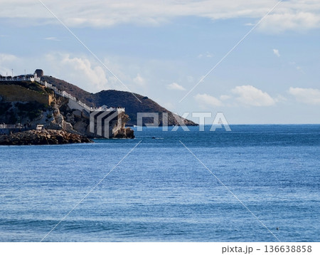 Ancient Fortress Situated On Cliffside Offering Breathtaking Views Of Ocean And Distant Harbor Ancient Fortress Situated On Cliffside Offering Breathtaking Views Of Ocean And Distant Harbor 136638858
