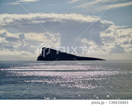 Isolated Island Silhouette Reflected In Sparkling Water With Peaceful Sky And Tranquil Mood Isolated Island Silhouette Reflected In Sparkling Water With Peaceful Sky And Tranquil Mood 136638861