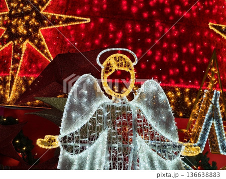 Calm Spiritual Angel Display Illuminated By Cool White LEDs Amid Softly Blurred Red Bokeh Backdrop Calm Spiritual Angel Display Illuminated By Cool White LEDs Amid Softly Blurred Red Bokeh Backdrop 136638883